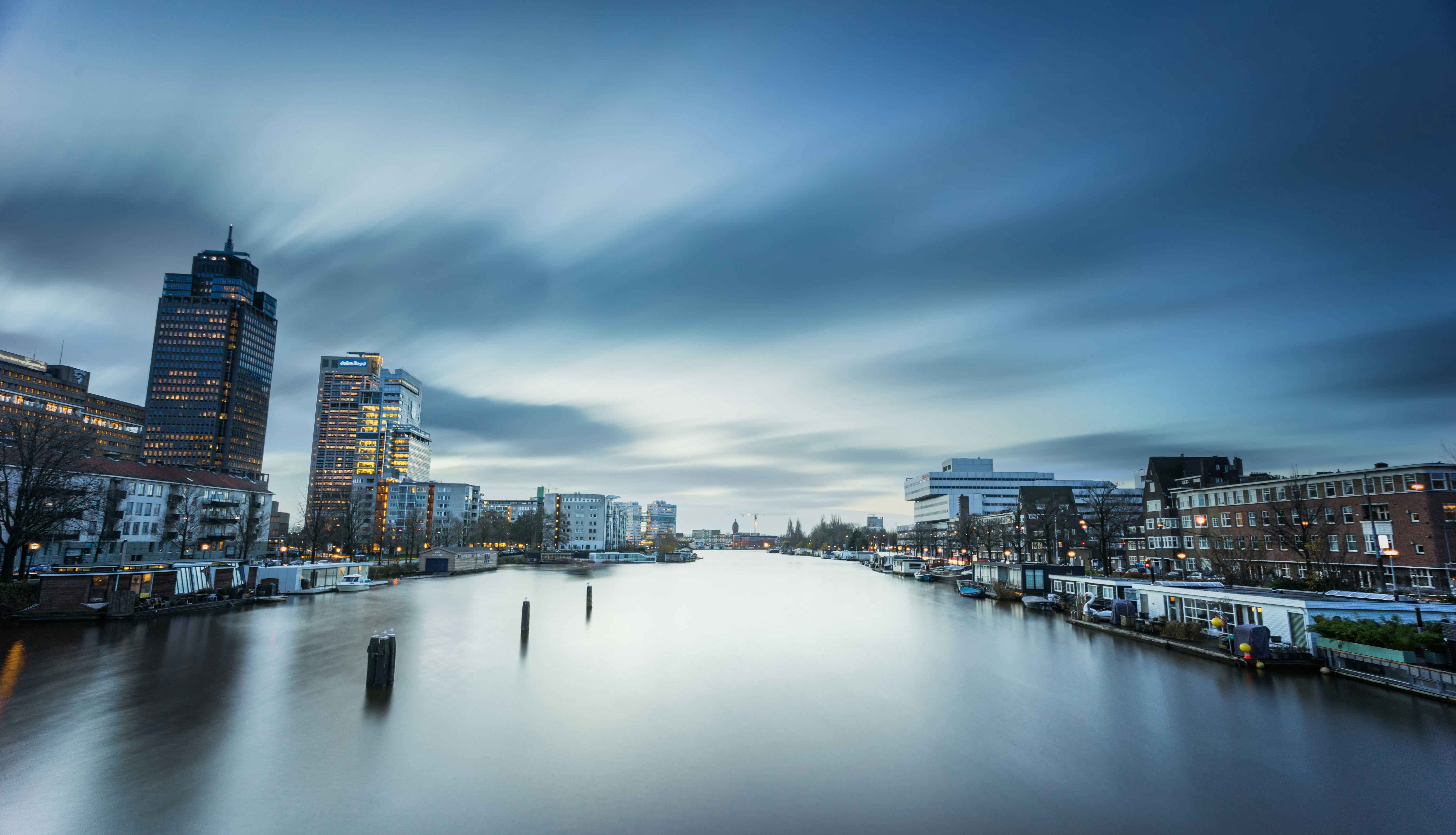 body of water in between high-rise buildings during daytime